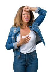 Poster - Beautiful middle age woman wearing casual denim jacket over isolated background Touching forehead for illness and fever, flu and cold, virus sick