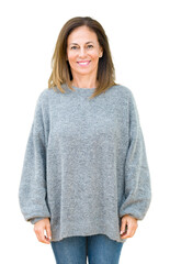 Poster - Beautiful middle age woman wearing winter sweater over isolated background with a happy and cool smile on face. Lucky person.