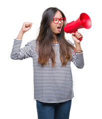 Sticker - Young asian woman holding megaphone over isolated background annoyed and frustrated shouting with anger, crazy and yelling with raised hand, anger concept