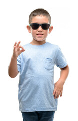 Sticker - Dark haired little child wearing sunglasses doing ok sign with fingers, excellent symbol