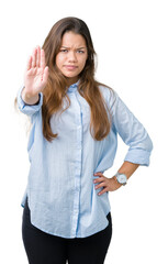 Canvas Print - Young beautiful brunette business woman over isolated background doing stop sing with palm of the hand. Warning expression with negative and serious gesture on the face.