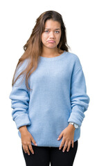 Sticker - Young beautiful brunette woman wearing blue winter sweater over isolated background depressed and worry for distress, crying angry and afraid. Sad expression.