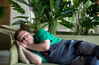 © ALEXEY - Rest after lunch Siesta in European countries worker sleeps on sofa during the day.