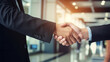 © Andrii Yablonskyi - business handshake photo blurred office in the background created with Generative Ai