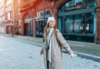 © Iryna - portrait of smiling young woman  having a fun time,  using phones  outdoor in a urban winter city. people, communication,  shopping and lifestyle concepts