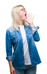 Canvas Print - Young beautiful blonde woman wearing glasses over isolated background shouting and screaming loud to side with hand on mouth. Communication concept.