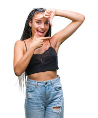 Wall Mural - Young braided hair african american with pigmentation blemish birth mark over isolated background smiling making frame with hands and fingers with happy face. Creativity and photography concept.