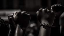 Cropped shot of hands rsed with closed fists. Multiple hands rsed up with closed fist symbolizing the black lives matter movement.