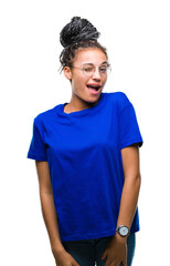 Canvas Print - Young braided hair african american girl wearing glasses over isolated background winking looking at the camera with sexy expression, cheerful and happy face.