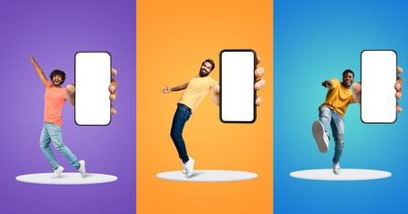 Cheerful Multiethnic Men Having Fun With Big Blank Smartphones In Hands