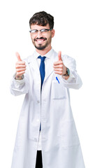 Sticker - Young professional scientist man wearing white coat over isolated background approving doing positive gesture with hand, thumbs up smiling and happy for success. Looking at the camera, winner gesture.