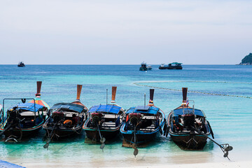 Wall Mural - Longtail Boat on Beach at Koh Lipe island in Thailand. Summer colorful seascape with boats and tropical beach. Beautiful paradise in sandy seaside. Peaceful andaman sea.