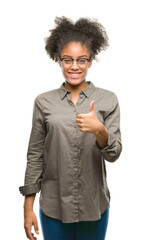 Sticker - Young afro american woman wearing glasses over isolated background doing happy thumbs up gesture with hand. Approving expression looking at the camera with showing success.