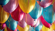 Collection of vibrant helium balloons in various colors.