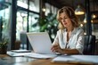 © Lumina Frame - Busy mid aged business woman working in office with laptop reading document. Mature professional female manager lawyer attorney holding paper finance report sitting at desk in office. Generative AI