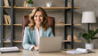 © gary - Happy smiling mature mid aged professional business woman manager executive or lawyer attorney looking at camera at workplace working on laptop computer technology in office sitting at desk, portrait
