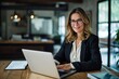 © Lumina Frame - Smiling mature mid aged professional business woman manager executive or lawyer attorney looking at camera at workplace working on laptop computer technology in office sitting at desk, Generative AI