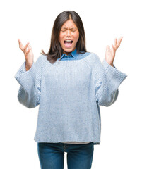 Poster - Young asian woman wearing winter sweater over isolated background celebrating mad and crazy for success with arms raised and closed eyes screaming excited. Winner concept