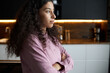 © Anatoliy Karlyuk - Profile portrait of young african american female chef standing with folded arms on background with stylish kitchen, looking at copy space with pensive face, planning delicious dinner