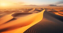 The Tranquil Aerial Scene Of A Desert, Illuminated By The Setting Sun