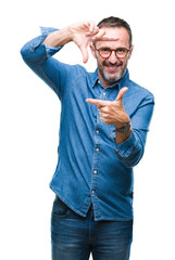 Canvas Print - Middle age hoary senior man wearing glasses over isolated background smiling making frame with hands and fingers with happy face. Creativity and photography concept.