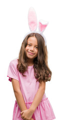 Poster - Brunette hispanic girl wearing easter rabbit ears with a happy face standing and smiling with a confident smile showing teeth