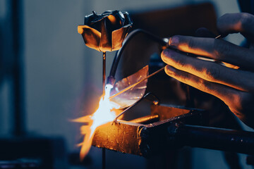 A craftsman welding a metal rose