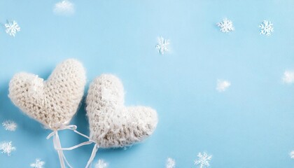 Wall Mural - knitted fluffy hearts on light blue background