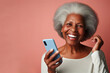 An elderly black woman smiling and laughing with her phone against a colored background. ai generative
