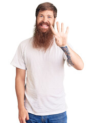 Wall Mural - Handsome young red head man with long beard wearing casual white tshirt showing and pointing up with fingers number four while smiling confident and happy.