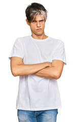 Sticker - Young hispanic man wearing casual white tshirt skeptic and nervous, disapproving expression on face with crossed arms. negative person.