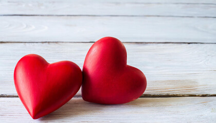 Valentines day background with two red hearts on white wooden table