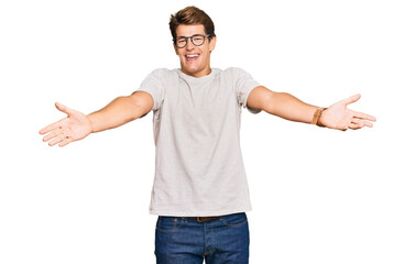 Wall Mural - Handsome caucasian man wearing casual clothes and glasses smiling cheerful offering hands giving assistance and acceptance.