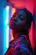 © Darya Lavinskaya - Beautiful young African American girl looking at camera against neon lights background