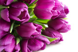 Fototapeta Tulipany - A still-life photo of a springtime bouquet of purple tulips lying on white background. Mother's day, Easter, birthday greeting card concept.
