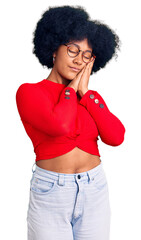 Poster - Young african american girl wearing casual clothes and glasses sleeping tired dreaming and posing with hands together while smiling with closed eyes.