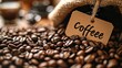 A background of roasted coffee beans and a small cardboard tag with the word 