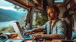 © visoot - Man sitting inside a motorhome with laptop. Generative AI.