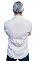 Sticker - Middle age hispanic with grey hair wearing casual white shirt standing backwards looking away with crossed arms