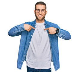 Wall Mural - Young caucasian man wearing casual clothes looking confident with smile on face, pointing oneself with fingers proud and happy.