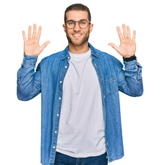 Canvas Print - Young caucasian man wearing casual clothes showing and pointing up with fingers number ten while smiling confident and happy.