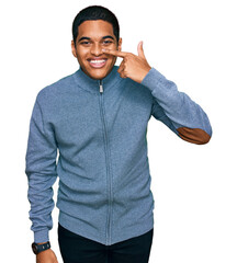 Wall Mural - Young handsome hispanic man wearing casual sweatshirt pointing with hand finger to face and nose, smiling cheerful. beauty concept