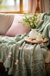 green and pink embroidered throw in a cozy farmhouse as spring home decor