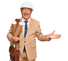 Wall Mural - Senior caucasian man wearing safety helmet holding blueprints celebrating victory with happy smile and winner expression with raised hands