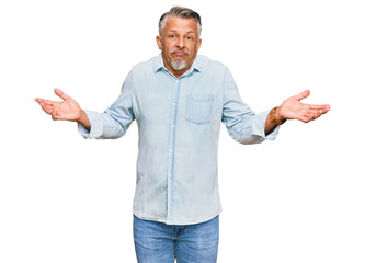 Poster - middle age grey-haired man wearing casual clothes clueless and confused expression with arms and han