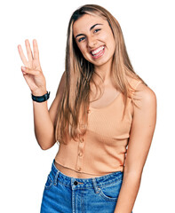 Canvas Print - Hispanic young woman wearing casual summer shirt showing and pointing up with fingers number three while smiling confident and happy.