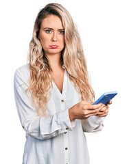 Poster - Young blonde woman using smartphone depressed and worry for distress, crying angry and afraid. sad expression.