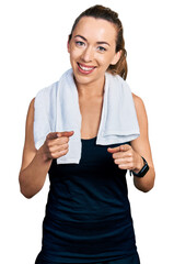 Sticker - Young caucasian woman wearing sportswear and towel pointing fingers to camera with happy and funny face. good energy and vibes.