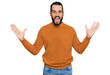 © Krakenimages.com - Young man with beard wearing casual winter sweater celebrating victory with happy smile and winner expression with raised hands
