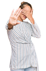 Beautiful blonde woman wearing business shirt and glasses covering eyes with hands and doing stop gesture with sad and fear expression. embarrassed and negative concept.